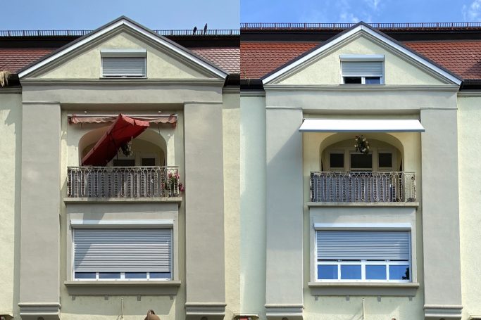 Balkonansicht mit rotem Sonnenschirm und geschlossenem Fenster auf der linken Seite.